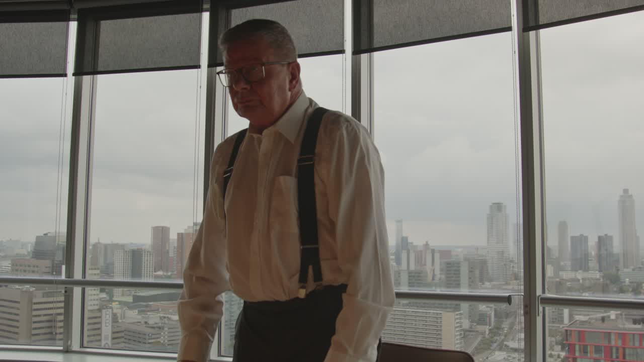Wide shot of an angry CEO standing up and hitting the table in anger