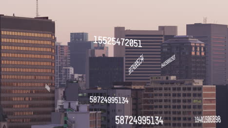 animation of changing numbers and data processing against aerial view of tall buildings