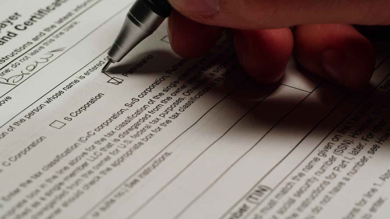 Hand Checking Partnership Box on Tax Form