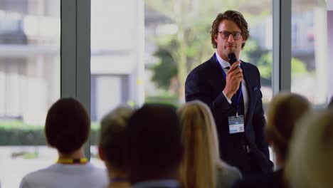 male speaker speaks in a business seminar at modern office 4k