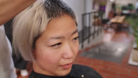 woman getting a haircut at a hair salon