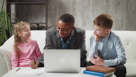 English-teacher-conducts-private-lesson-to-schoolchildren