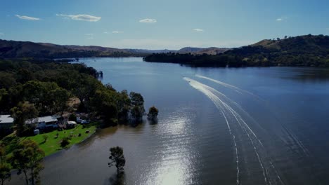 jet skis racing into the distance on lake eildon aerial tracking