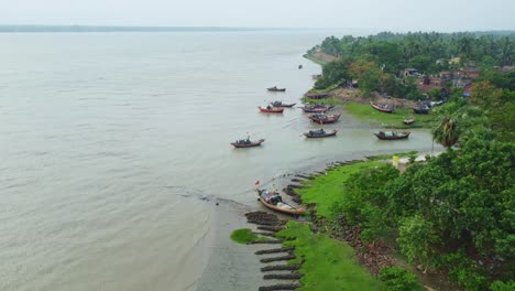 Fishing Boats Docked Along a Lush Riverbank