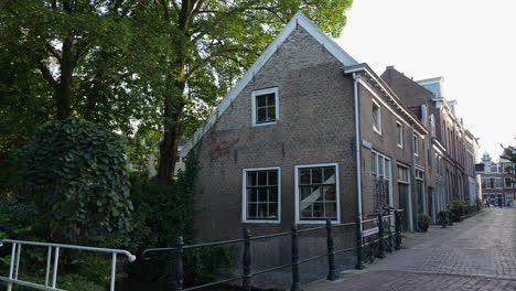 walkway bridge over canal along dutch street at park houtmansplantsoen in gouda, netherlands