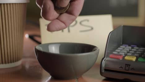 Hands-putting-coins-in-tip-jar