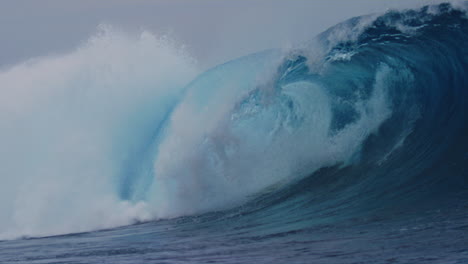 slow motion sideview of surfer bailing off of board as it gets tossed over the falls at cloudbreak fiji