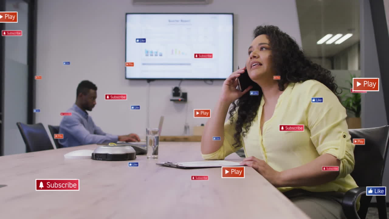 Mid-adult woman calling in business meeting, showing animated play subscribe like icons