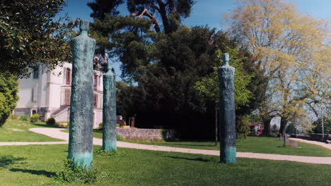 static shot of three statues next to conservatory of music l'ouest vaudois during the day in nyon, canton of vaud, switzerland