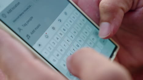 man typing message on mobile phone while working