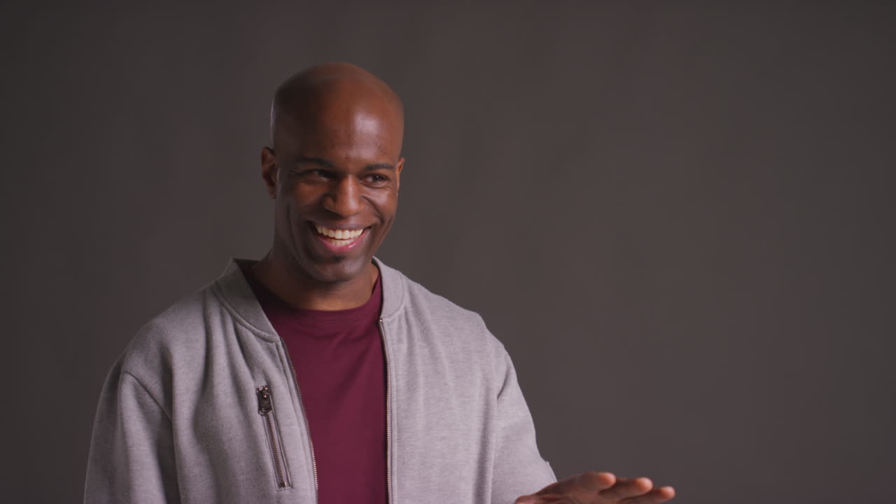 Studio Portrait Of Excited Mature Man Celebrating Good News Standing Against Grey Background 1
