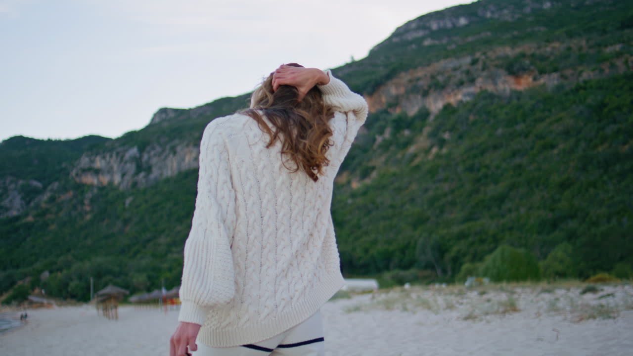 Girl strolling seashore evening smiling closeup. Happy woman walking sandy beach