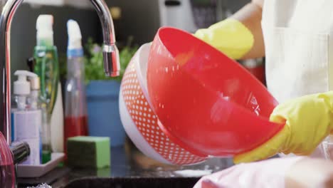 grandmother and granddaughter washing utensil in kitchen sink 4k