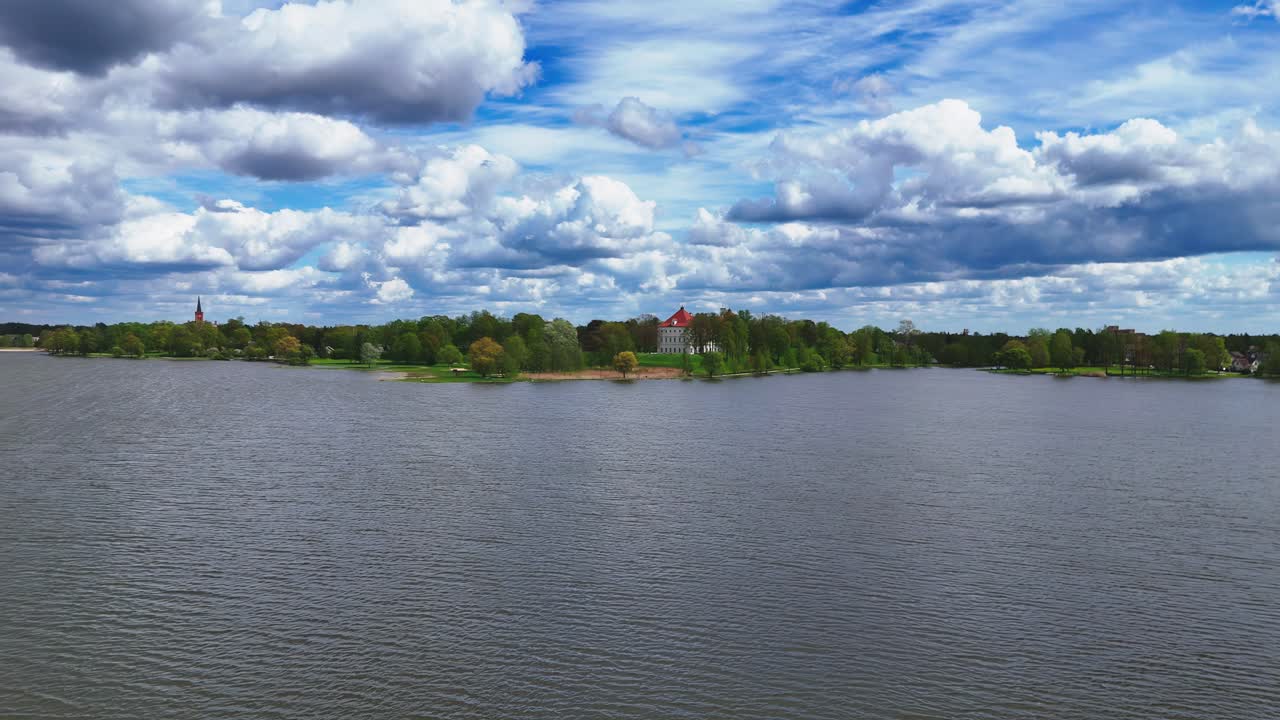 Aerial shot with dense clouds over Lake Širvėna in Lithuania