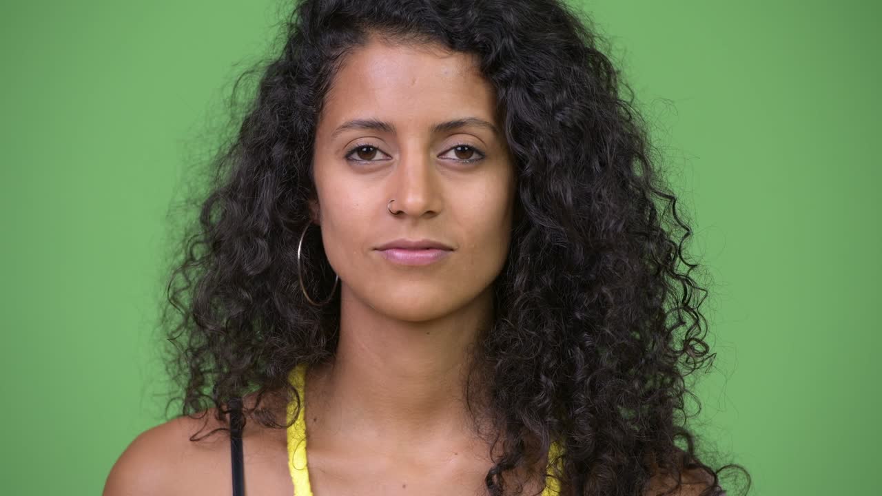 Young beautiful Hispanic woman covering mouth as three wise monkeys concept