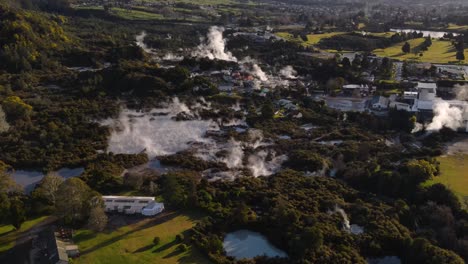 Popular-tourist-attraction-with-hot-springs,-pools-and-geyeser-in-Rotorua,-New-Zealand---aerial-drone