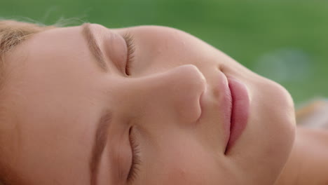 close up portrait beautiful woman lying on grass in peaceful countryside enjoying summer vacation relaxing in nature