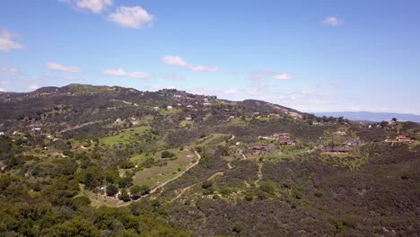 Aerial-View-of-Malibu-houses-in-Santa-Monica-Mountains-in-Los-Angeles,-California-on-a-sunny-summer-day