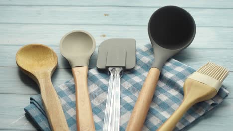 assorted kitchen utensils on a blue checkered cloth