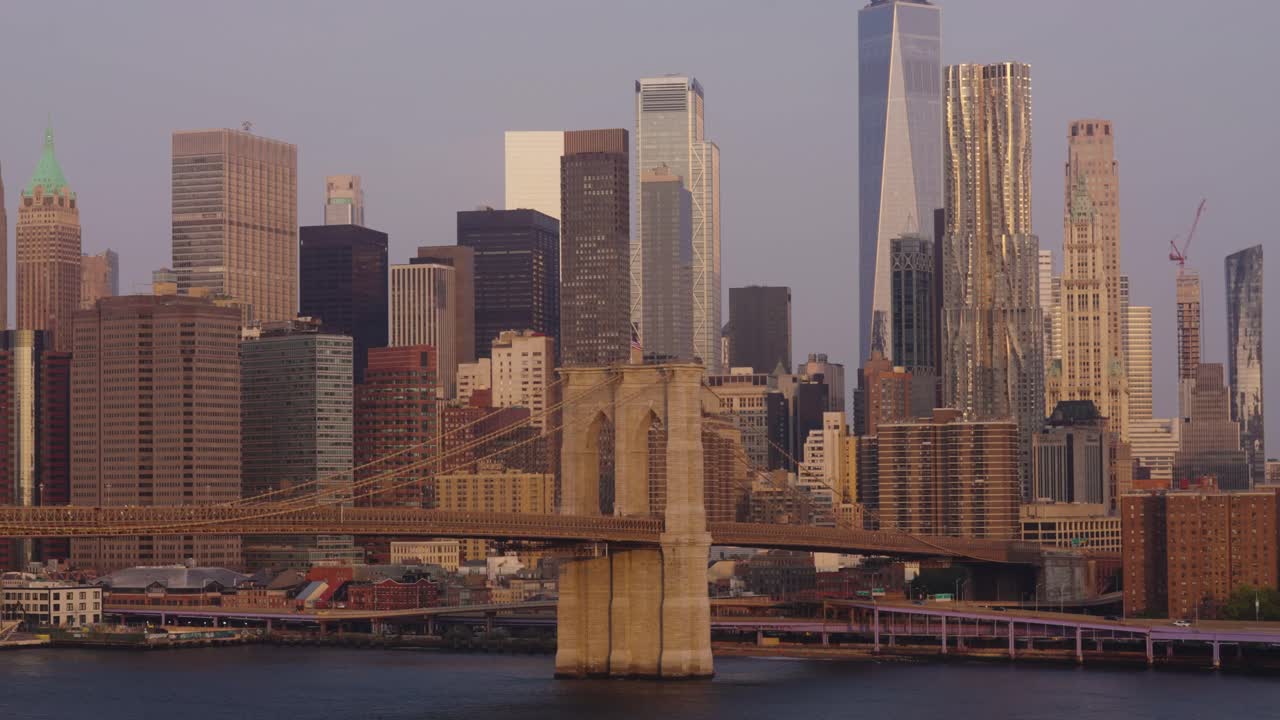 Static wide shot of gigantic Skyline of New York City with new modern One World Trade Center during golden hour
