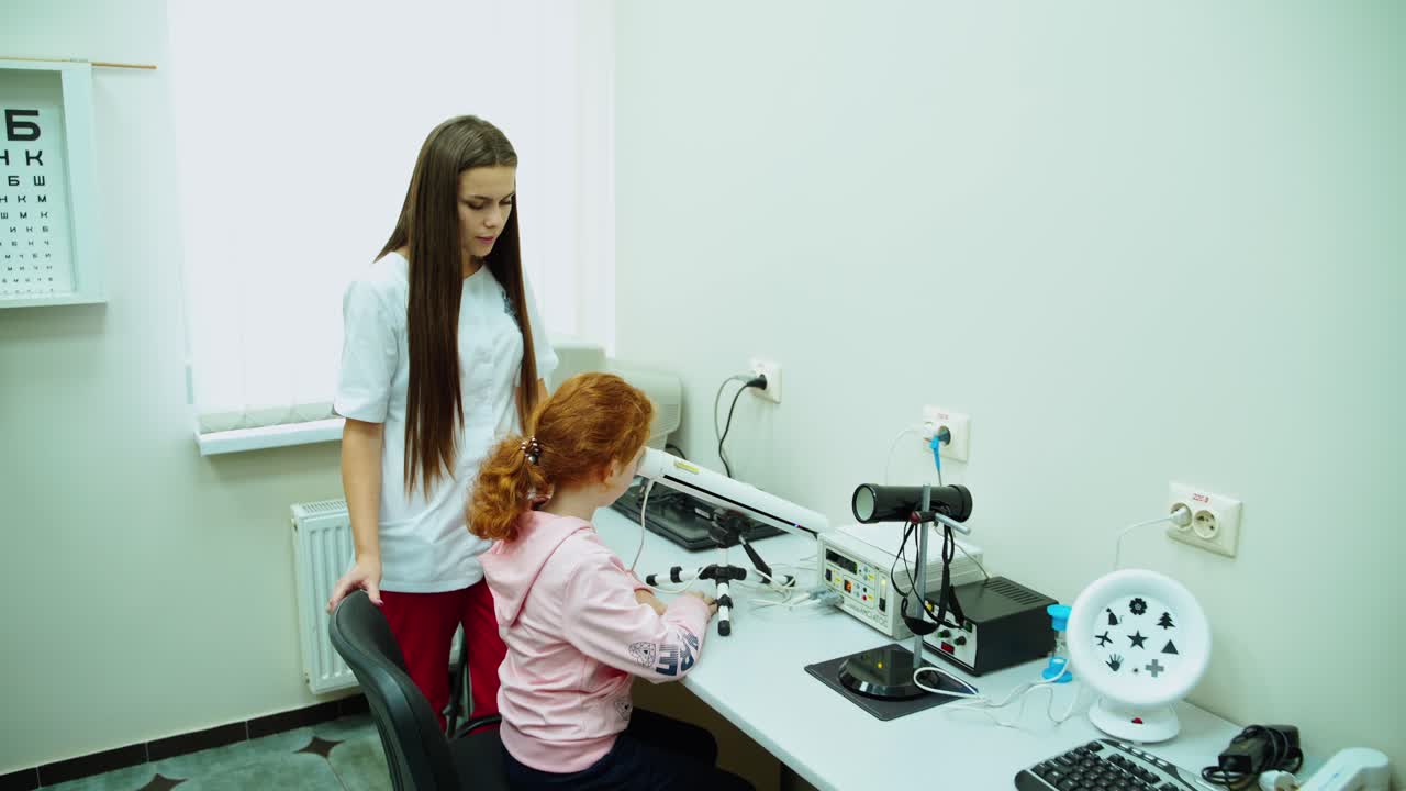 Girl patient at doctor ophthalmologist. Young girl checking his eyesight on special medical equipment