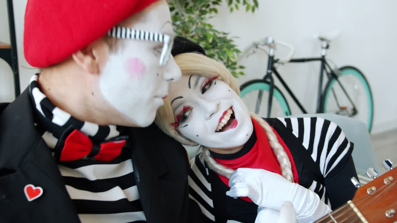 Mime Couple Performing with Guitar