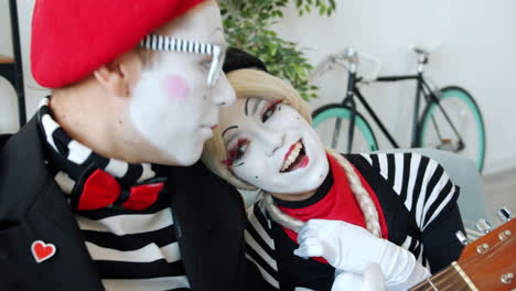 mime couple performing with guitar
