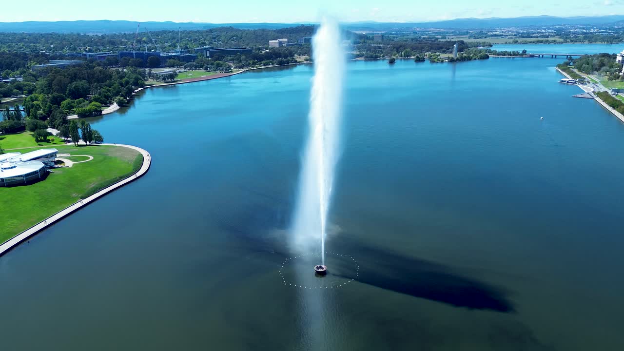 Drone aerial landscape of water jets spraying in air memorial fountain design landmark of Lake Burley Griffin Canberra capital city ACT Australia Parliament travel tourism design lagoon reservoir
