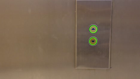 person pressing elevator buttons