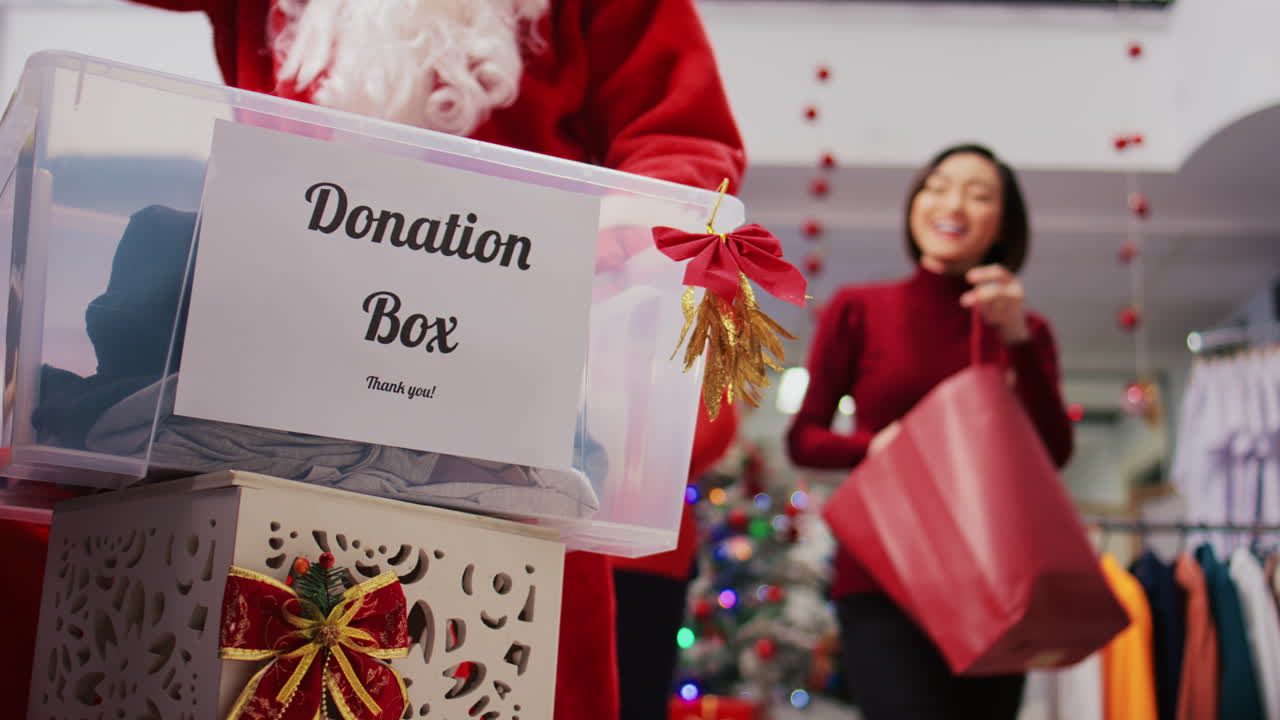 Close up shot of donation container in fashion boutique. Generous customers touched by festive spirit donating clothes for humanitarian efforts during Christmas holiday season