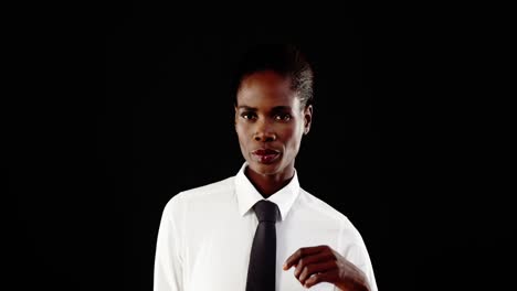 Androgynous-man-posing-against-black-background