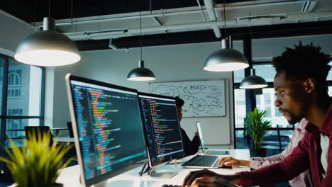software developers coding on computers in a modern office environment