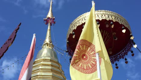 pagodas with flags waving against a blue sky