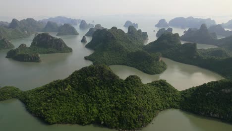 aerial of beautiful landscape of limestone mountain cliffs in ha long bay vietnam on hazy morning