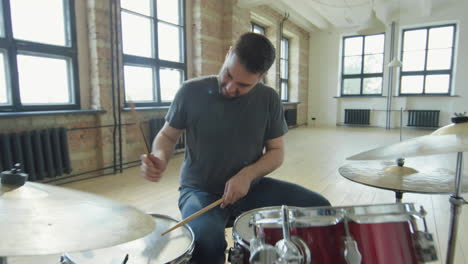 professional male drummer playing drumkit