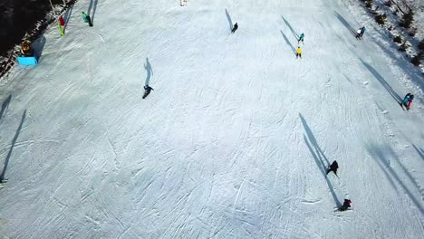 Aerial-top-view-of-snowboarders-in-Topolita-Snow-Summit,-Transylvania-Romania