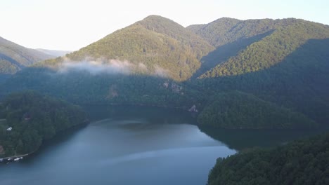 wide aerial view of tarnita lake and the surrounding landscape of hills and forest