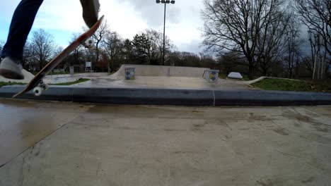 A-skateboarder-is-seen-jumping-on-top-of-a-small-marble-ledge-and-grinding-with-both-trucks-until-the-skateboard-slips-away-and-the-skateboarders-falls-to-the-ground-on-it's-back