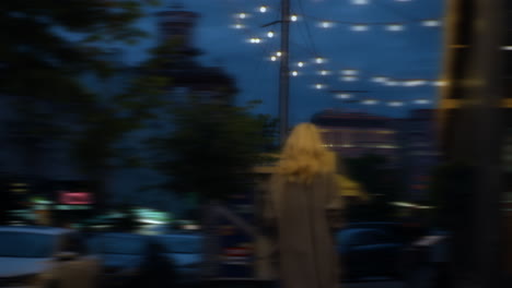 lady walking evening city lights in urban background buildings.