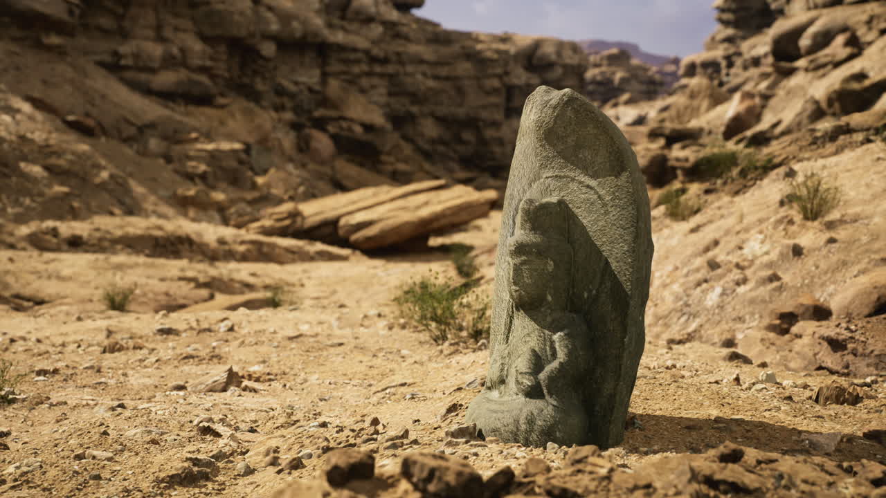 Ancient stone carving of a deity found in arid landscape