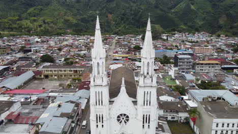 aerial view of a majestic white church in a mountain town