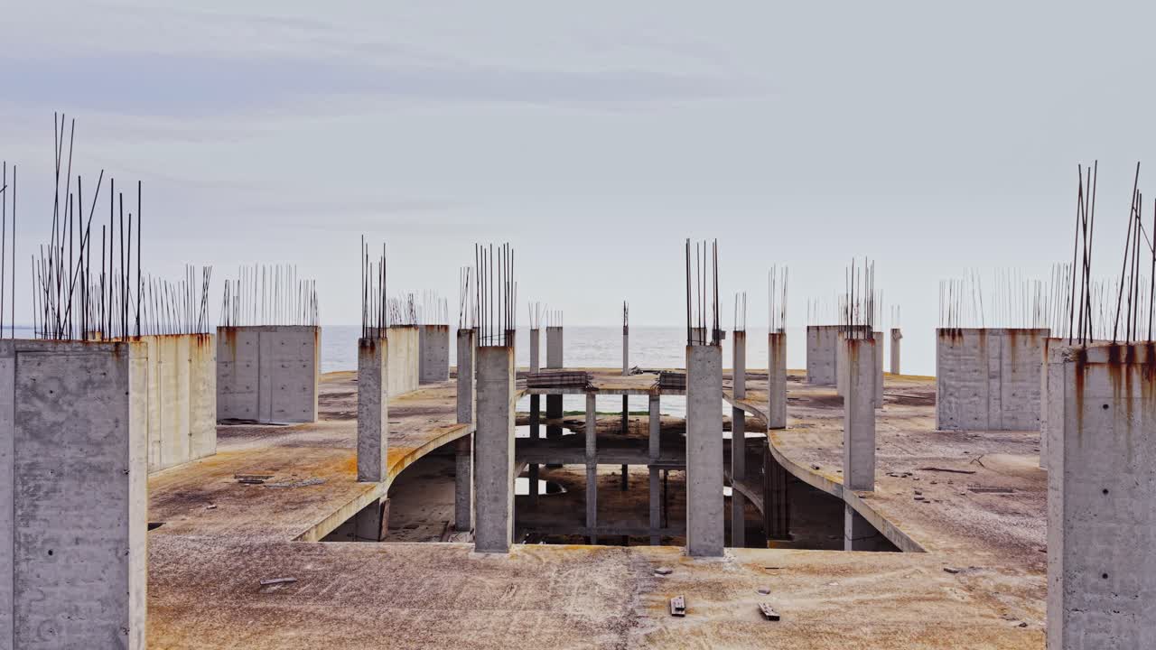 View of an unfinished concrete structure with exposed beams from above