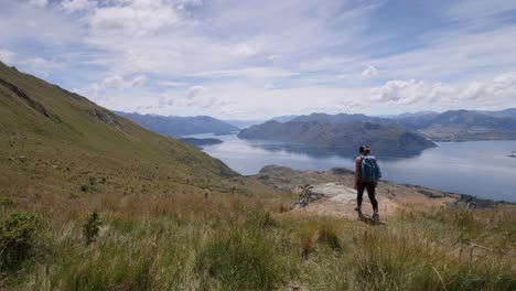 woman hiking to peak in new zealand