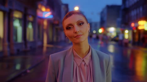 elegant woman standing on a wet city street at night