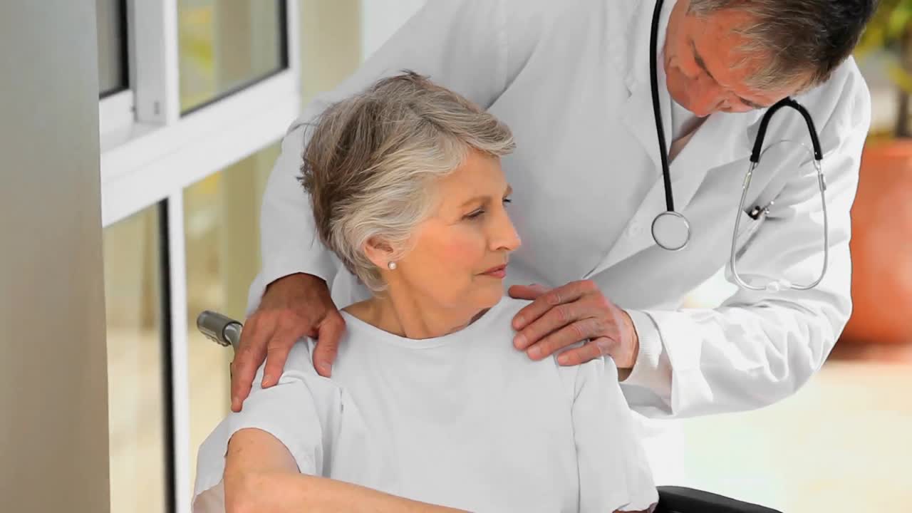 Doctor sharing a joke with woman in wheelchair