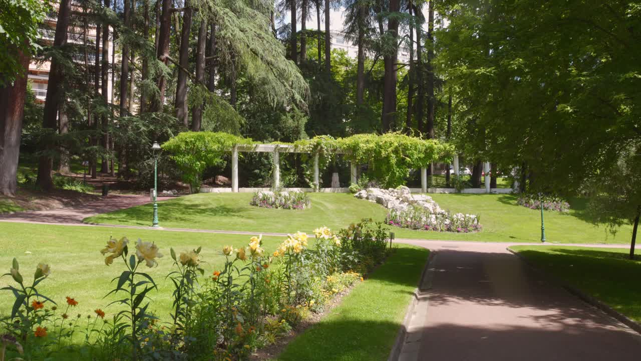 Profile view of Parc floral des thermes (thermal floral park) in Aix-les-Bains, France during daytime. 4k.