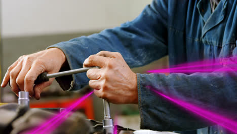 Animation-of-flashing-light-trails-pattern-moving-over-caucasian-male-car-mechanic