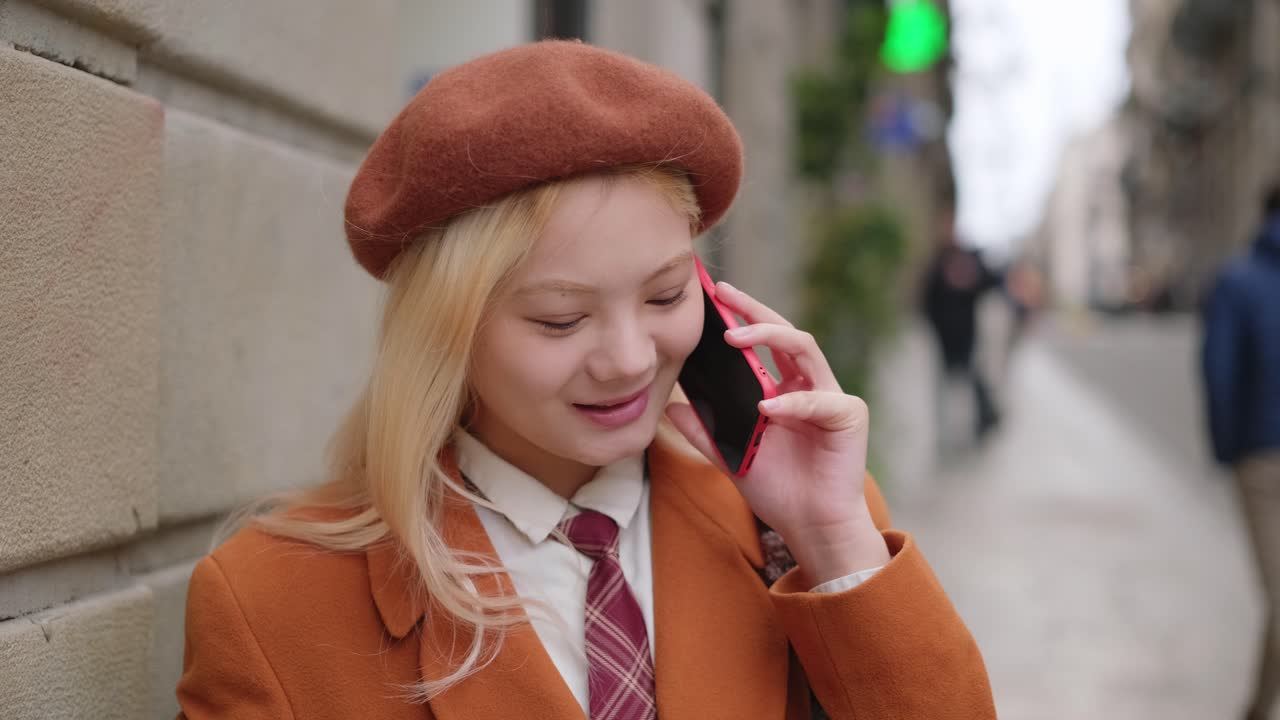 Woman talking on the phone on a city street