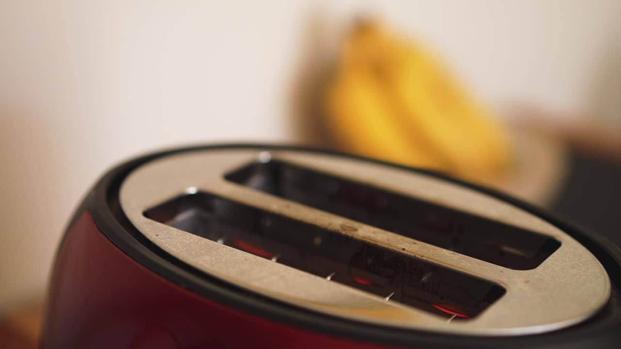 Sliced white bread popping out of toaster