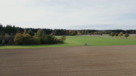 Embark-on-a-visual-journey-through-the-autumnal-magic,-as-our-drone-captures-the-breathtaking-tapestry-and-serene-ambiance-of-a-woodland-painted-in-the-warm-hues-of-fall